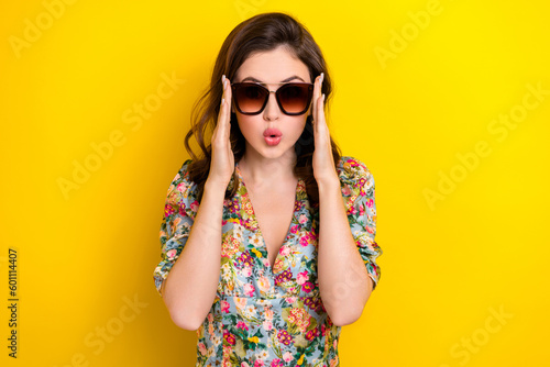 Photo of shiny impressed lady wear retro flower print blouse arms dark eyeglasses isolated yellow color background