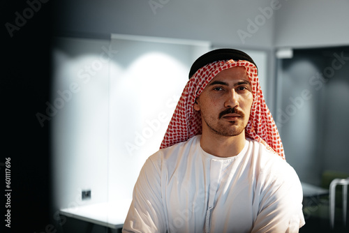 Successful muslim businessmen in traditional outfit in his office photo