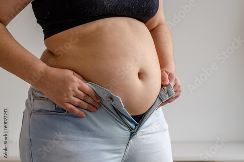 fat woman trying to zip up her jeans pants