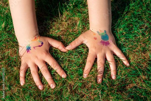Shimmering sparkling glitter tattoo on a child's hand at a birthday party