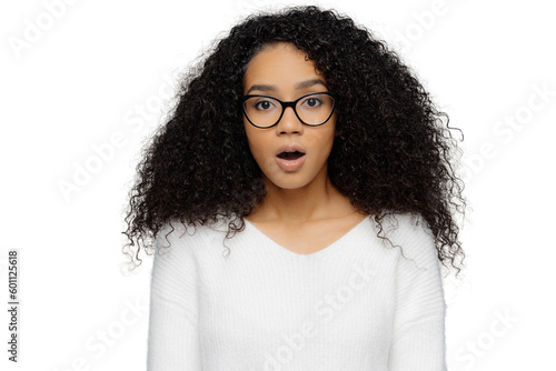 Shocked woman with frizzy hair and glasses, isolated on white background, surprised and stunned photo