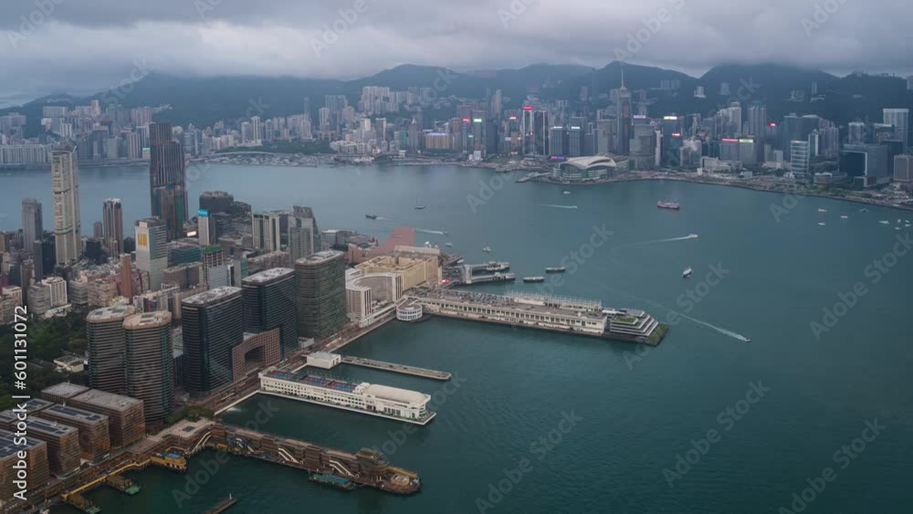 4K Time lapse Panoramic view of Hong Kong City during day to night. View of Hong Kong central financial district, Victoria Harbour and residential buildings illuminated after sunset from the Kowloon. 4K Time lapse Panoramic view of Hong Kong City during day to night. View of Hong Kong central financial district, Victoria Harbour and residential buildings illuminated after sunset from the Kowloon.