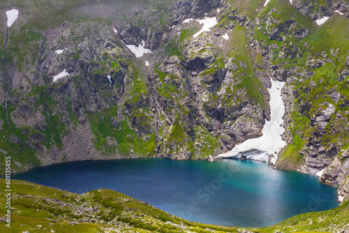 small blue lake in green mountain