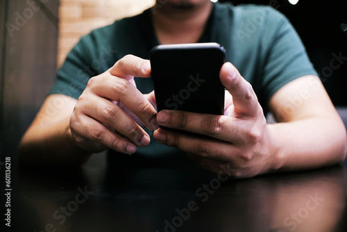 Cropped view of male hands holding cell phone with blank screen.Man using electronic gadget, typing message or checking newsfeed on social networks.