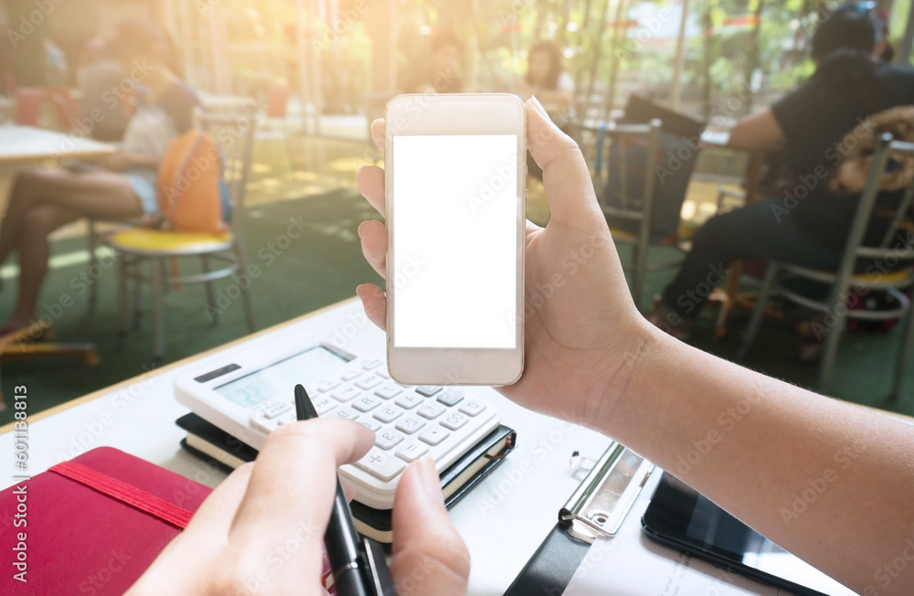 Fototapeta premium Businesswoman showing blank smart phone screen. girl using smart phone in cafe.