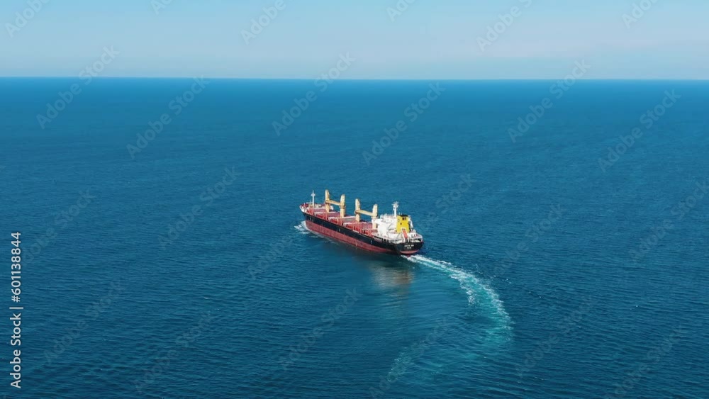 A large ship with oil products sails on the sea on a sunny day, aerial view A large ship with oil products sails on the sea on a sunny day, aerial view