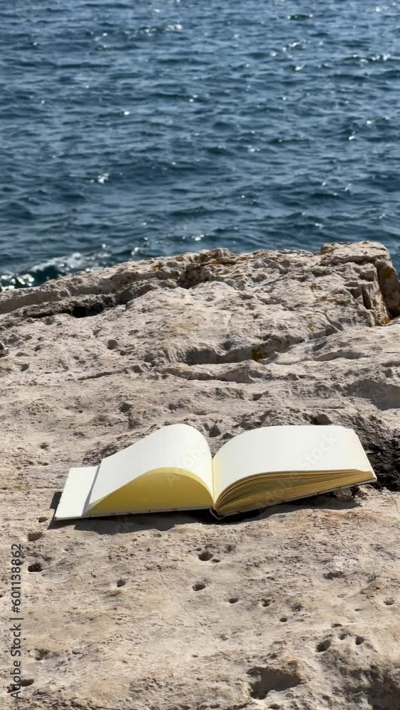 Wind Flipping Notebook Pages on Sea background Wind Flipping Notebook Pages on Sea background