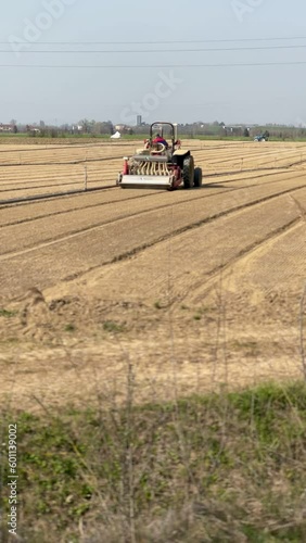 Farm field, tractor cultivated land photo