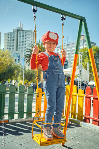 latin boy playing in an outdoor park with mario bros clothes in the city of la paz bolivia photo