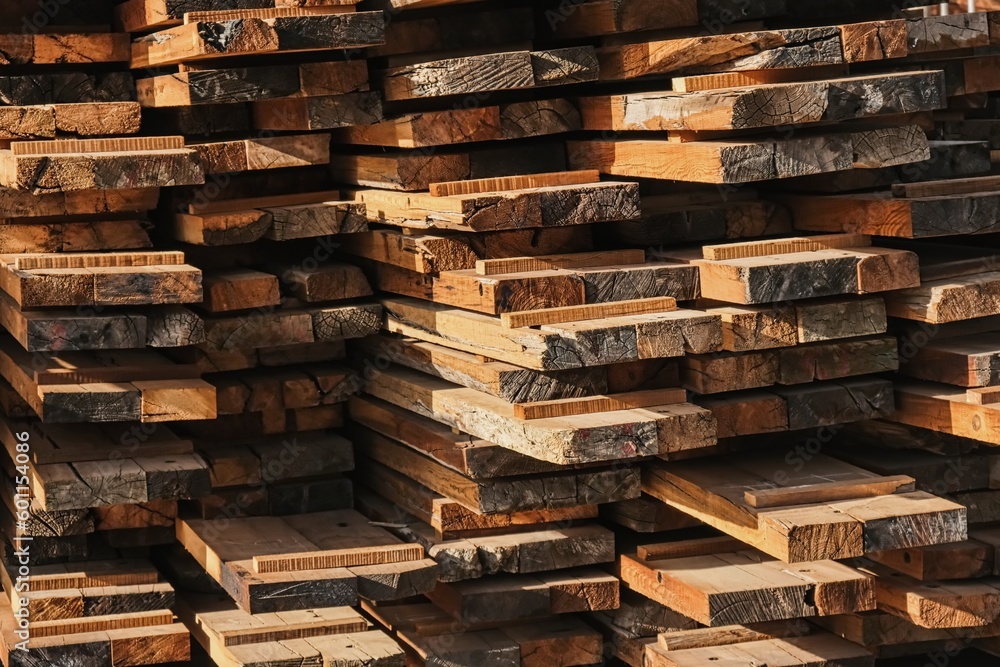 Wooden planks heap as background. Air-drying timber stack. Wood outdoors warehouse. Pile of wooden boards in sawmill, planking, sawing boards. Wooden blank construction material. Lumber Industry. Wooden planks heap as background. Air-drying timber stack. Wood outdoors warehouse. Pile of wooden boards in sawmill, planking, sawing boards. Wooden blank construction material. Lumber Industry.