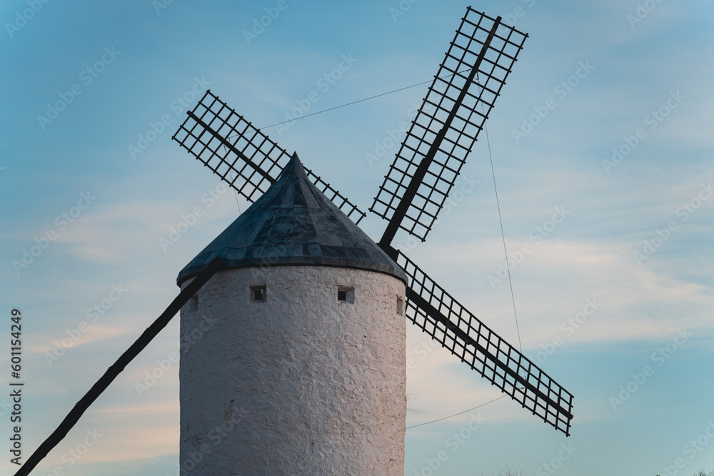 Isolated windill at sunset with cloudy sky Isolated windill at sunset with cloudy sky