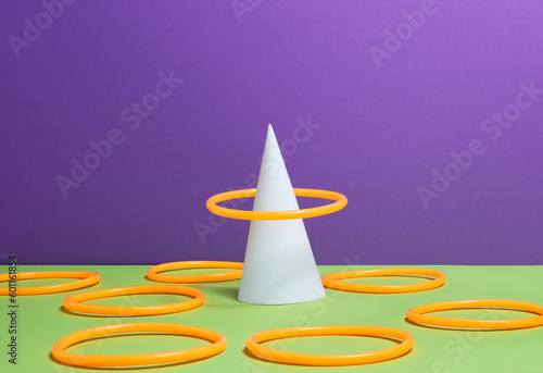 Canvastavla Accuracy concept - Orange ring over white cone, green surface, purple background