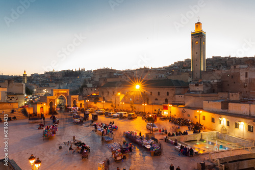 Arabic square Rcif in Fes in Morocco at sunset. People in market and street food.  
