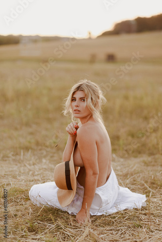 blond nude girl in a field on sunset, sunrise