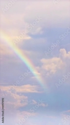 Vertical video Rainbow in cloudy sky timelapse loop, seamless looping animated background motion backdrop sky and clouds, beautiful weather