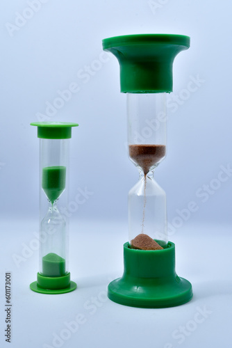 Glass hourglass on a white background. Multicolored glass hourglass.
