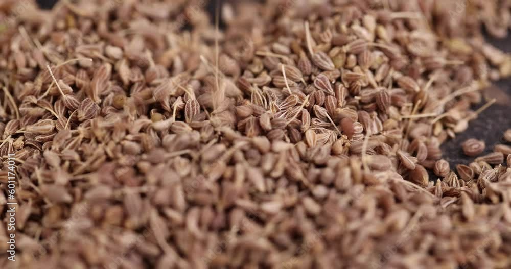 Small, fragrant anise spices on the board, scattered dried anise spices on the table