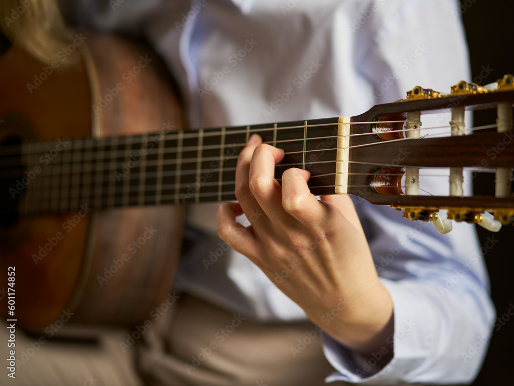 Fototapeta premium an unrecognizable person playing the spanish guitar playing a chord