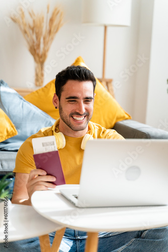 Optimistic man holding plane ticket and passport.