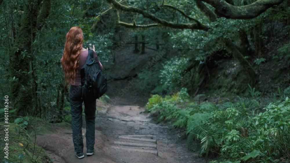Woman is in an enchanted forest taking a selfie. Woman is in an enchanted forest taking a selfie.
