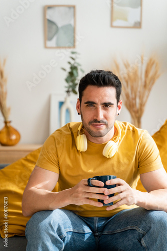 Thoughtful man drinking a cup of hot chocolate at home.