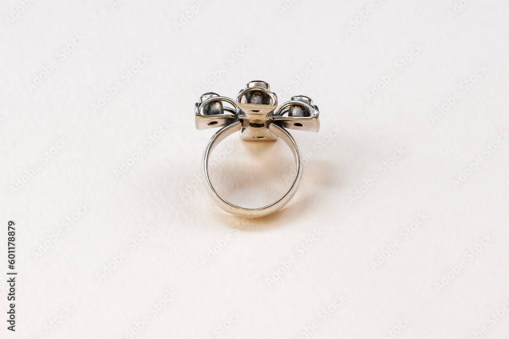 Unique silver cross ring with colorful gemstone crystals on a white background, vintage jewelry concept, promotional photo for an online jewelry store Unique silver cross ring with colorful gemstone crystals on a white background, vintage jewelry concept, promotional photo for an online jewelry store