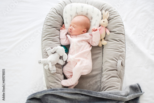 Принти на полотні Peacefully sleeping Caucasian newborn baby girl in a baby nest