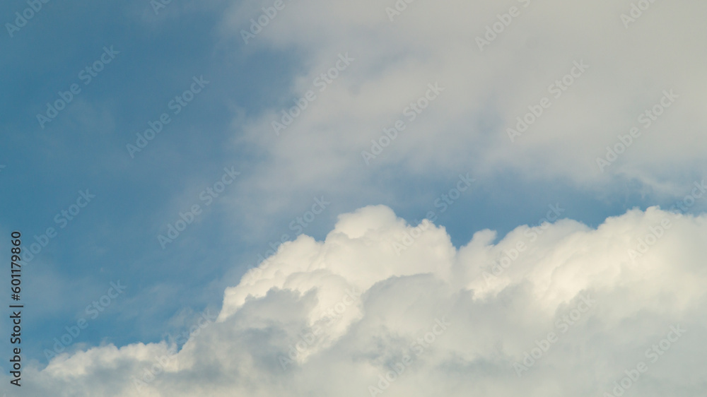 Blue sky with white clouds. Fluffy white clouds and blue sky. White fluffy clouds close-up Blue sky with white clouds. Fluffy white clouds and blue sky. White fluffy clouds close-up