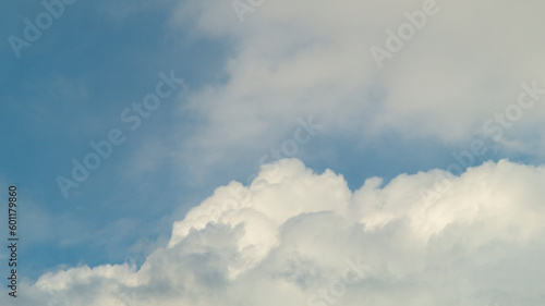 Blue sky with white clouds. Fluffy white clouds and blue sky. White fluffy clouds close-up