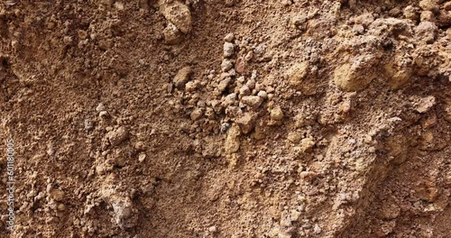 a pile of yellow-orange sand poured after the dug hole, freshly dug sand on the construction site