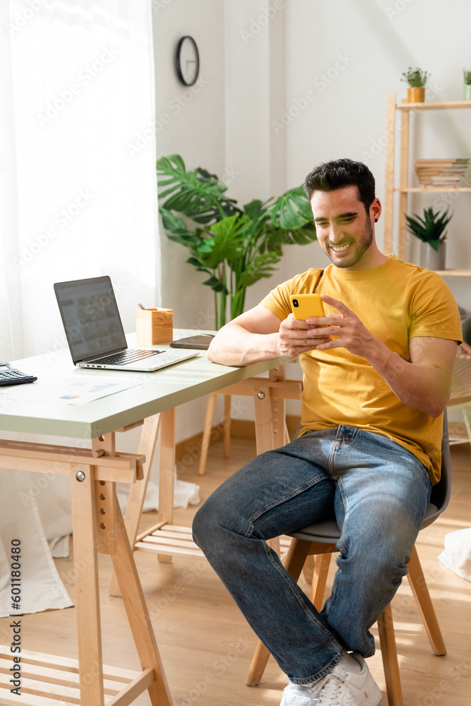 Freelance worker sitting at desk at home.