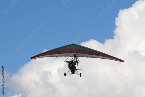 Valokuva Ultralight airplane flying in a cloudy sky