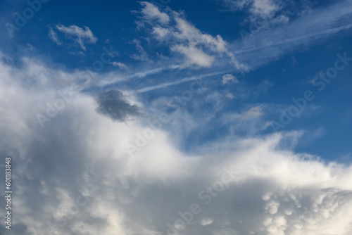 large and small clouds in blue sky