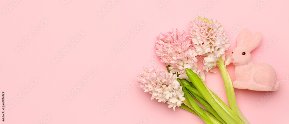 Beautiful hyacinth flowers and Easter bunny on pink background with space for text