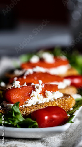 Slika na platnu Smoked salmon and goat cheese crostini served on a bed of salad greens