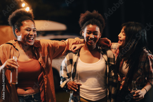 happy young woman friends person having fun to dance in bar-b-q food night party, camp fire friendship group in summer vacation holiday, nature campfire picnic with balefire in evening travel outdoor