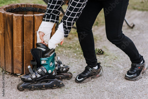 A girl, a woman athlete with broken arms in a cast, throws out roller skates on a trash can after an injury in sports. Close-up photography, portrait, end of career.