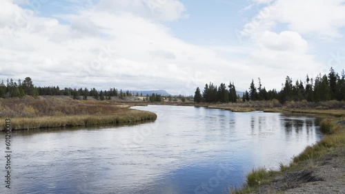 Madison river flows placidly along outside of Yellowstone national park in fall photo