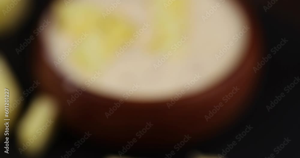 focus on a milk pineapple yogurt with pieces of pineapple and other fruits, natural yogurt with pineapple flavor and pieces of ripe pineapple focus on a milk pineapple yogurt with pieces of pineapple and other fruits, natural yogurt with pineapple flavor and pieces of ripe pineapple