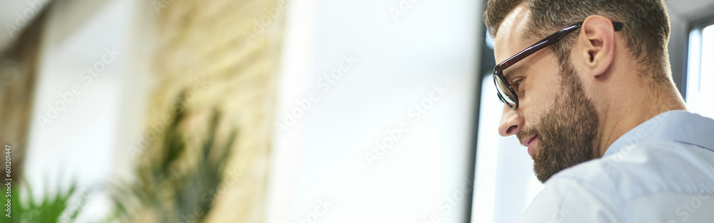 Fototapeta premium Gladsome man enjoying meeting his colleagues online