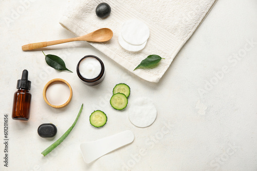 Composition with natural cosmetics, ingredients and towel on light background