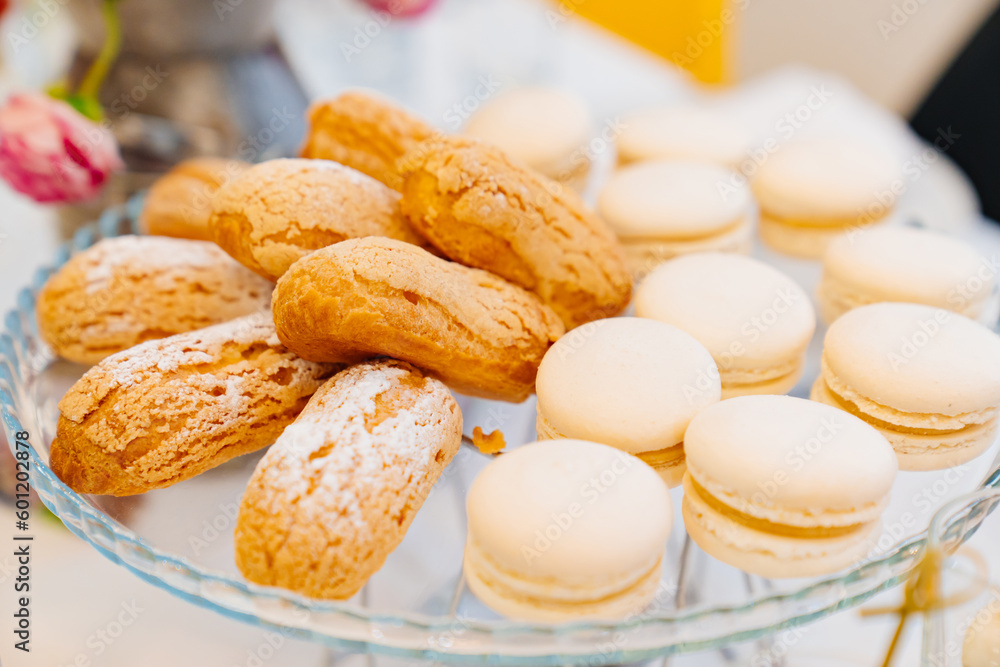 a plate of macarons cakes and ladies' fingers biscuits. 