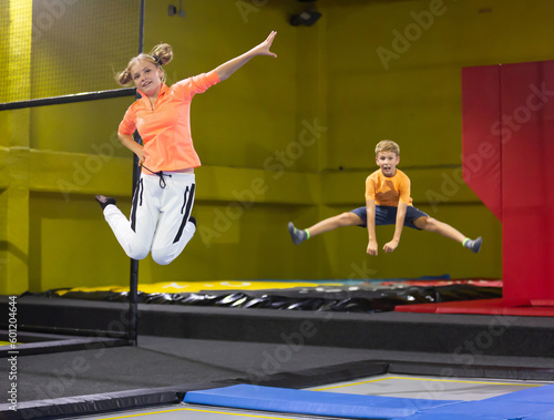 Happy cute little girl jumping on a trampoline indoors © JackF