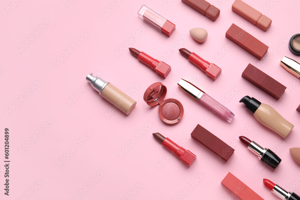 Decorative cosmetics with lipsticks and sponges on pink background Decorative cosmetics with lipsticks and sponges on pink background