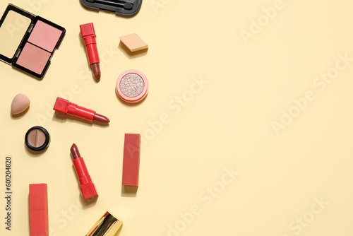 Fototapeta Naklejka Na Ścianę i Meble -  Decorative cosmetics with lipsticks and sponges on beige background