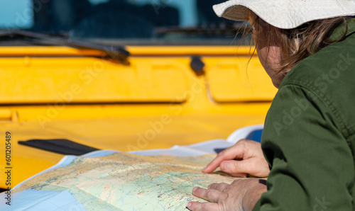 Wallpaper Mural On a Yellow 4x4: Travel Photo of a Woman Navigating with a Map Torontodigital.ca