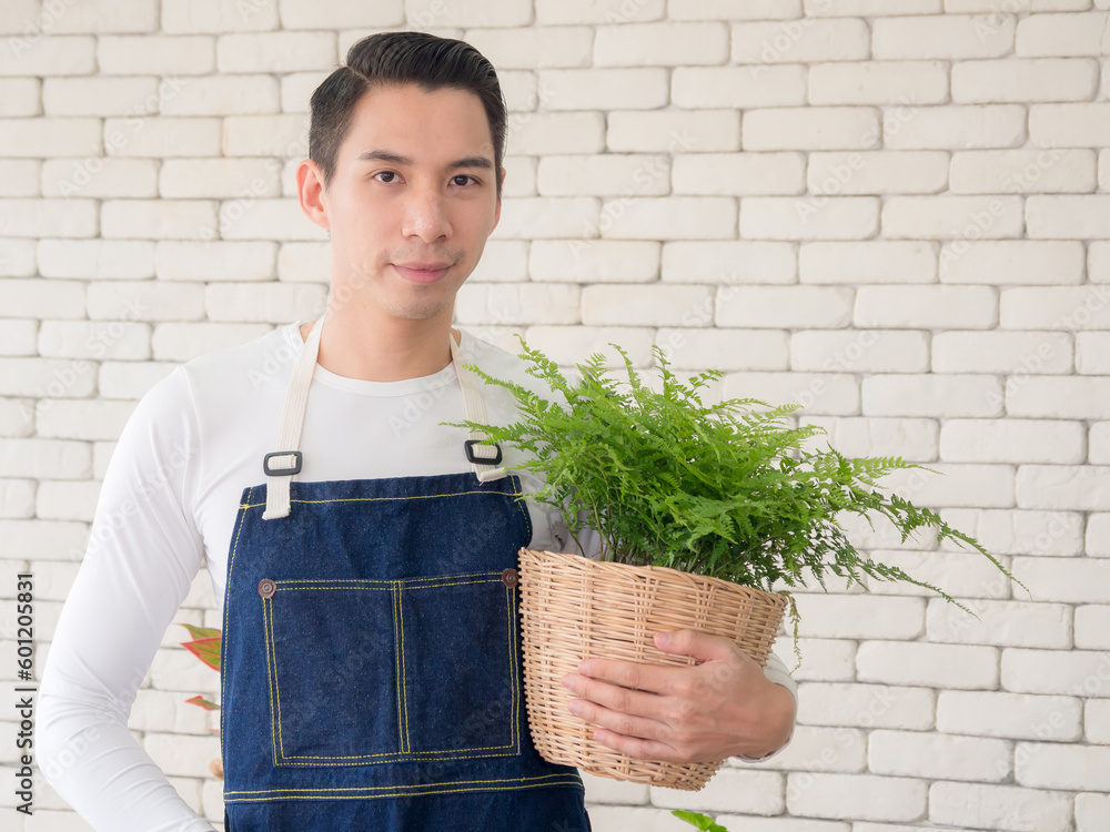 Portrait garden handsome cool young Asian boy man wearing white blouse with long black hair and smile fresh with bright smile look pot small tree leaf green plant in room shop Happy and relax Portrait garden handsome cool young Asian boy man wearing white blouse with long black hair and smile fresh with bright smile look pot small tree leaf green plant in room shop Happy and relax