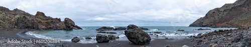 Huge amazing panorama shot of black sand beach and rocks surrounded by mountains and little bay in tenerife, canarias, spain © José Rego