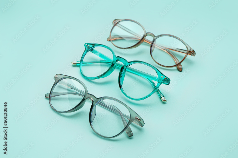 Different new eyeglasses on pale turquoise background Different new eyeglasses on pale turquoise background