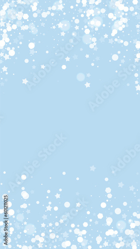 Beautiful snowfall christmas background. Subtle flying snow flakes and stars on light blue winter backdrop. Beautiful snowfall overlay template. Vertical vector illustration.